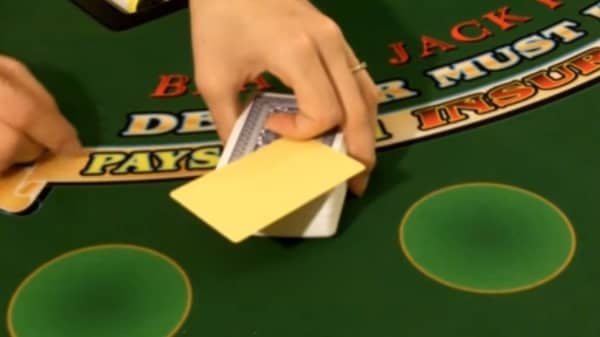 The dealer hands the cut card to the player on a single deck game The dealer hands the cut card to the player on a single deck game