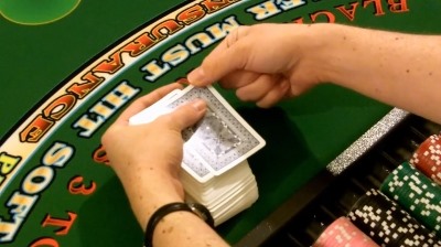 The dealer holds the top card in place The dealer holds the top card in place