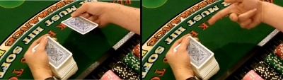 The dealer uses the middle finger to flip the card The dealer uses the middle finger to flip the card