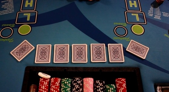 Dealer dealing 7 hands of 7 cards each in Pai Gow Poker