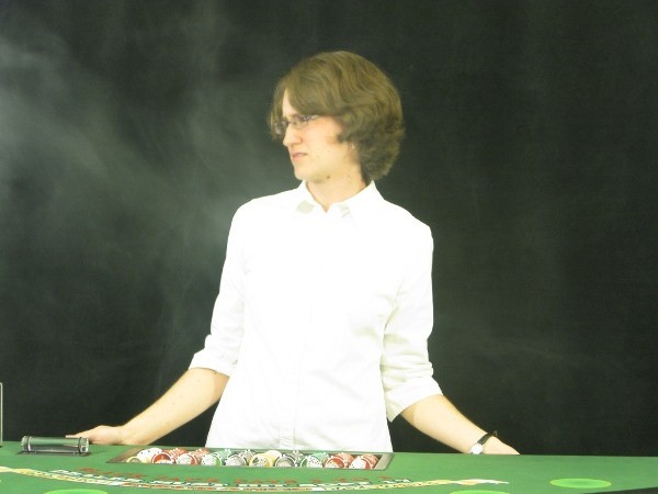 The player is blowing smoke in the dealers face The player is blowing smoke in the dealers face