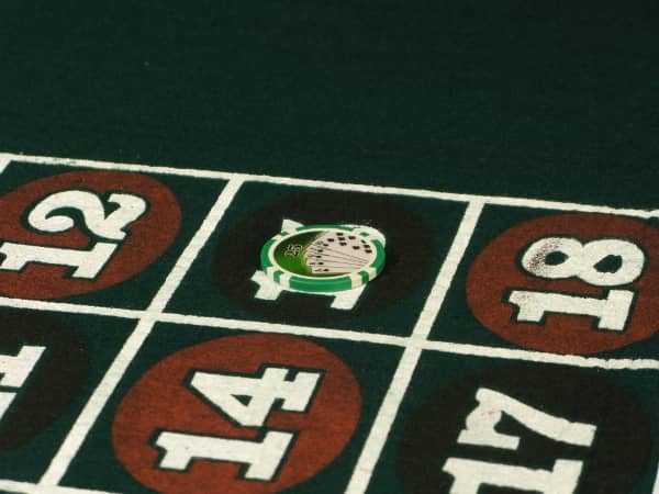 A large stack of chips is on one number on roulette
