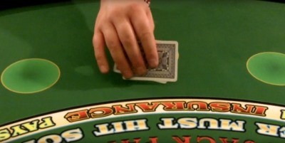 The player is blocking the view of their chips with their cards The player is blocking the view of their chips with their cards