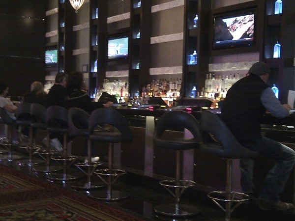 People are sitting at a bar People are sitting at a bar