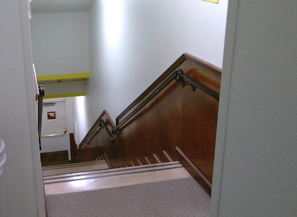 A long hallway and stairway A long hallway and stairway