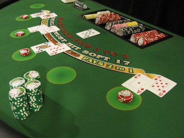 A large stack of green chips on the player's side of blackjack A large stack of green chips on the player's side of blackjack
