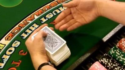 The dealer holds the deck in their dominate hand The dealer holds the deck in their dominate hand