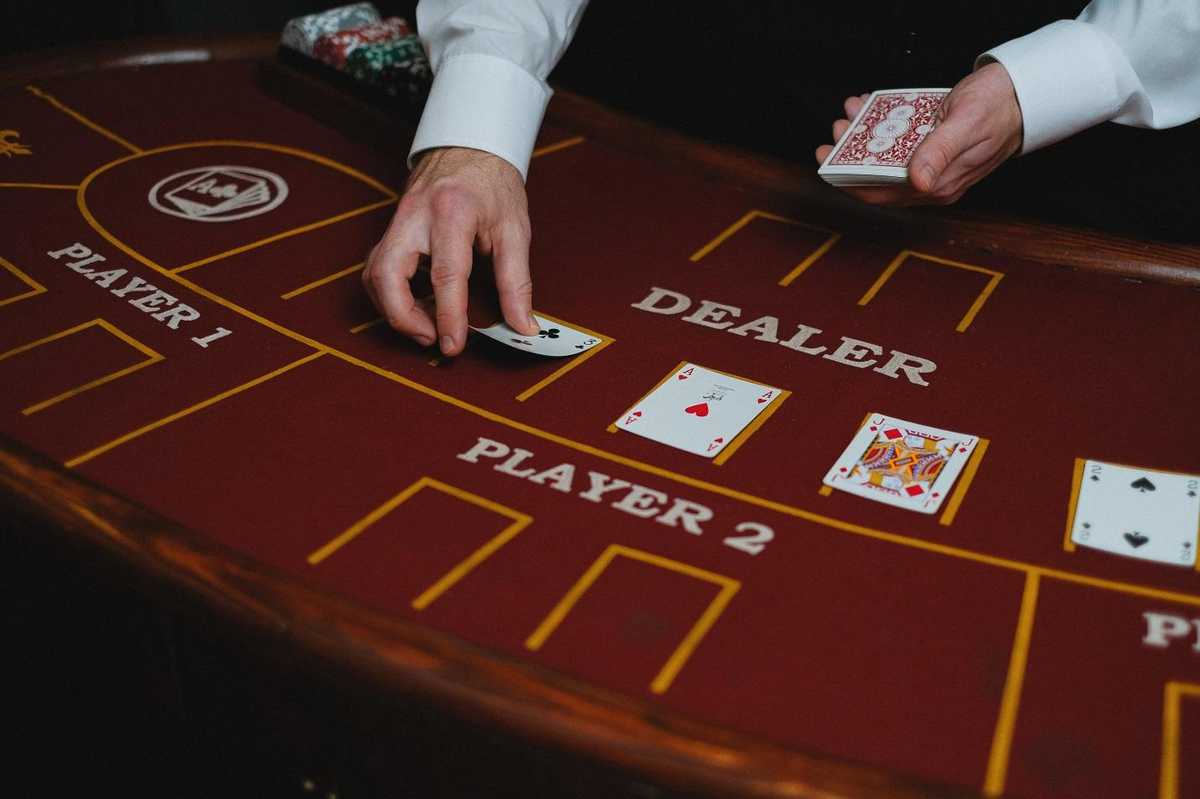 a dealer hand places a card on the table