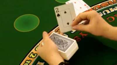 The dealer is hitting the players hand on a handheld deck