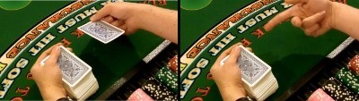 The dealer uses the middle finger to flip the card The dealer uses the middle finger to flip the card
