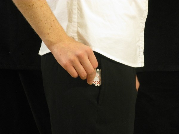 The dealer is putting a black chip in their pocket The dealer is putting a black chip in their pocket