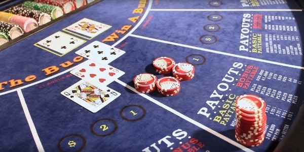 The dealer turns over the cards and spreads them so the cameras can see them The dealer turns over the cards and spreads them so the cameras can see them