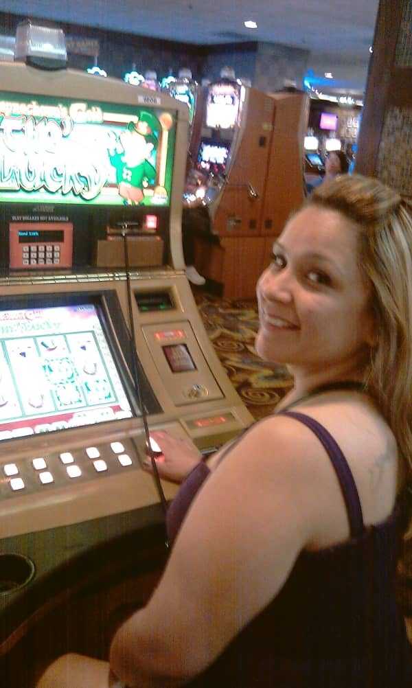A pretty woman playing a slot machine