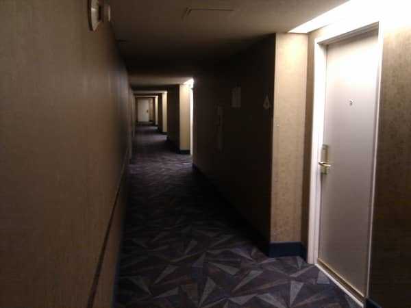 A hallway full of hotel rooms