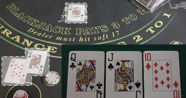 The initial cards are out and the dealer is determining the hand The initial cards are out and the dealer is determining the hand