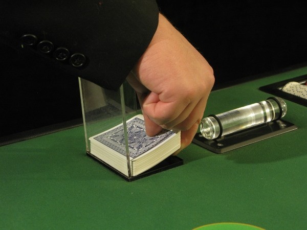 The floorman is picking up the discard deck The floorman is picking up the discard deck