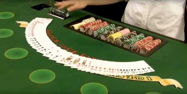 The dealer spreads the cards on the table