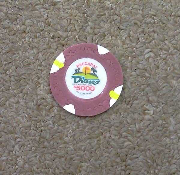 A 5,000 dollar chip lying on the carpet