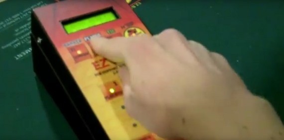 The dealer inputs the hand in the machine The dealer inputs the hand in the machine