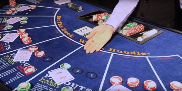 The dealer is pointing at the cards The dealer is pointing at the cards
